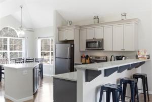 a kitchen with white cabinets and black appliances at Waterfront Condo near Marina in Branson +31 photos