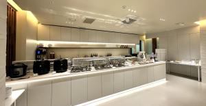 a kitchen with a counter with a stove in it at Villiv Inn-the City Namsan in Seoul