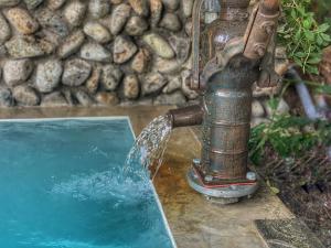 a fire hydrant pouring water into a pool of water at Heidi Guest House in Yuzawa