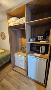 a small kitchen with a microwave in a room at Cantinho de Milfontes 1 in Vila Nova de Milfontes