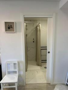 a bathroom with a walk in shower next to a door at Casa da Zéfinha - STUDIO in Cinfães +15 photos