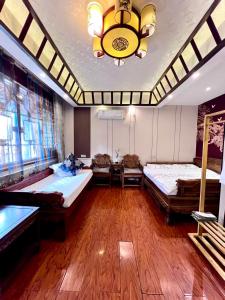 a large room with two beds and a chandelier at Pingyao HongJingYuanGuesthouse in Pingyao