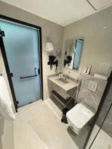 a bathroom with a sink and a toilet and a shower at فندق جديل2 - Jadeel Hotel 2 in Al Khobar +22 photos