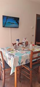 a dining room table with a table cloth on it at Peperilla House in Luni +42 photos