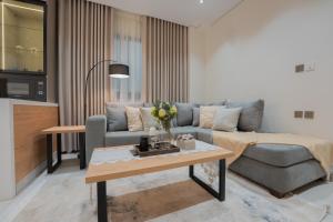 a living room with a couch and a table at Luxury & Modern Brand New Family Apartments in Medina