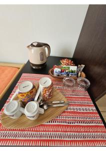 a table with a tray with cups and a tea kettle at Guest house Il Giardino in Città in La Spezia