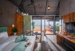 a bedroom with a bed and a view of the ocean at Elysian Vale in Vagamon