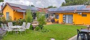 a house with solar panels on the roof at SONHOS dreams Self catering Garden Cottages in Bloemfontein