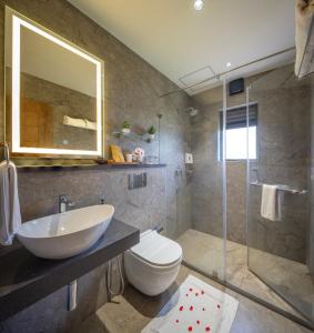 a bathroom with a sink and a toilet and a shower at Elysian Vale in Vagamon +95 photos