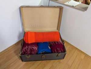 an open suitcase sitting on the floor with clothes at Peste Vale in Poşaga de Sus