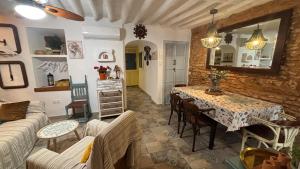 a living room with a table and a couch at La Maison de Magdala in Ronda