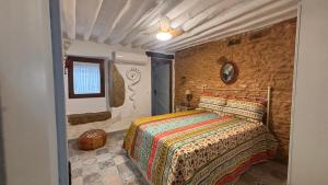 a bedroom with a bed and a stone wall at La Maison de Magdala in Ronda +61 photos