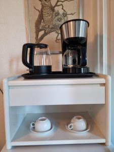 a coffee maker sitting on top of a shelf at Bayer Apartments Copenhagen in Rødovre