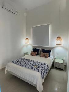 a bedroom with a large bed with two pillows at TAMA Hotel Santa Marta in Santa Marta +40 photos