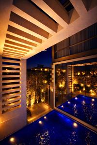 a building with a swimming pool at night at Villa Nuri Konaklama in Çiftlik +34 photos