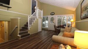 a living room with a staircase and a couch at Relaxing Beginnings in Cape May Point