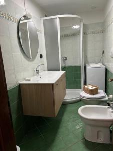 a bathroom with a sink and a toilet and a mirror at Casa San Rocco in Busalla +23 photos