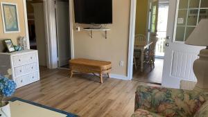 a living room with a couch and a tv at Sail Away in Cape May Point