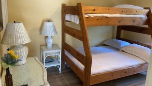 a bedroom with two bunk beds and two lamps at Sail Away in Cape May Point