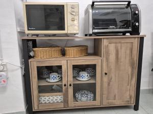 a microwave and a toaster oven on top of a cabinet at Casa Castillo in Montán