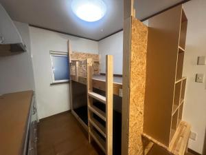 a room with a bunk bed and a closet at 旭川ロキ in Asahikawa +5 photos