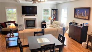 a living room with a couch and a table at Seamans Folly On Broad in Cape May