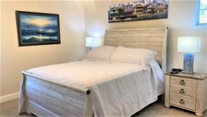 a bedroom with a bed and a night stand with two lamps at Seamans Folly On Broad in Cape May