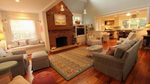 a living room with a couch and a fireplace at Cutest Cottage On Central in Cape May Point