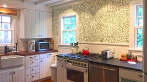 a kitchen with a stove and a microwave at 637 Seagrove in Cape May Point +19 photos