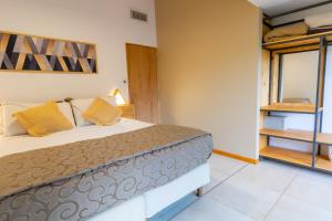 a bedroom with a bed and a window at Cabañas del Cerro in Valle Grande +38 photos