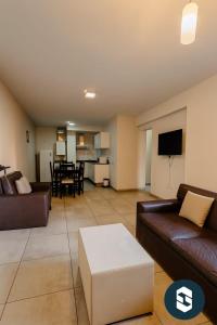 a living room with a couch and a table at Central Suites Hotel in Villa Carlos Paz
