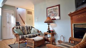 a living room with a couch and chairs and a fireplace at Failte in West Cape May