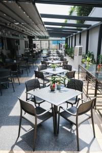 a row of tables and chairs on a patio at Silver Moon Hotel in Abidjan