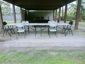 a group of tables and chairs sitting under a pavilion at Uya Mina Homestay in General Luna