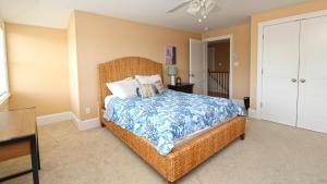 a bedroom with a bed with a blue and white comforter at 209 Congress Street in Cape May