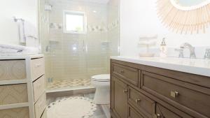 a bathroom with a shower and a toilet and a sink at Beach Croft in West Cape May +23 photos