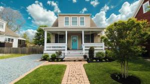 a house with a blue door and grass at Beach Croft in West Cape May
