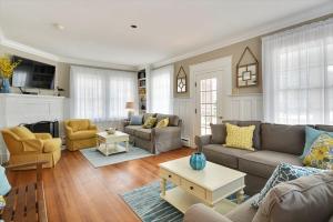 a living room with a couch and a table at The Cape May Diamond in Cape May