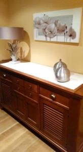 a wooden cabinet with a tea kettle on top of it at Hotel Casbas in Senegüé