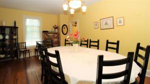 a dining room with a table with a vase of flowers on it at Cottage At 37 Jackson in Cape May