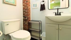 a bathroom with a white toilet and a sink at Cottage At 37 Jackson in Cape May +29 photos