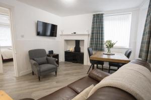 a living room with a couch and a table at Taigh Oisean 4 Birnam Place Pitlochry in Pitlochry