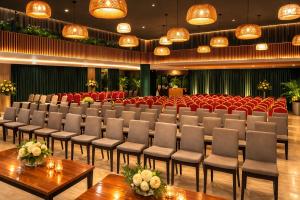 a conference room with chairs and tables and a stage at Hotel Boulevard Nairobi, City Centre CBD in Nairobi +246 photos