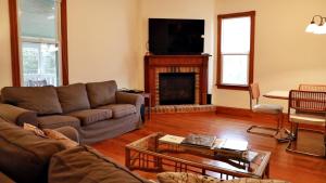 a living room with a couch and a fireplace at Relief Cape May Point in Cape May Point
