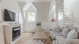 a living room with a couch and a fireplace at The Ocean Loft At Kings in Cape May