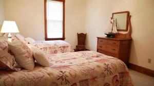 a bedroom with a bed and a dresser and a mirror at Relief Cape May Point in Cape May Point