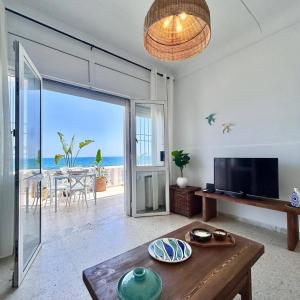 a living room with a view of the ocean at Maison Azur la Marsa plage in Tunis