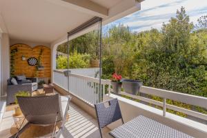 a balcony with chairs and a view of trees at Le Clos de Vallaurias in Vallauris