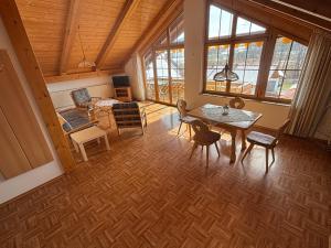 a living room with a table and chairs at Appartementhaus Marion in Bad Bayersoien