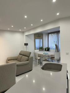 a living room with a couch and a table at Hôtel de Provence in Cannes +76 photos
